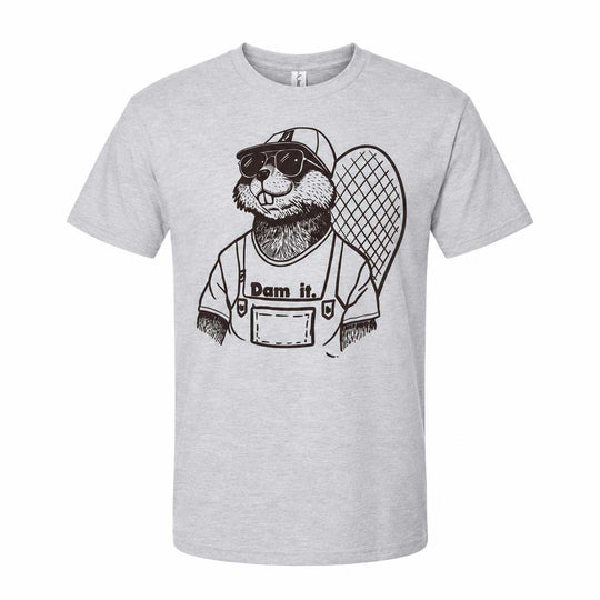 A light heather gray short-sleeve crewneck t-shirt featuring a black line art graphic of a beaver wearing sunglasses, a baseball cap, and overalls with the text 'Dam it.' printed on the front.