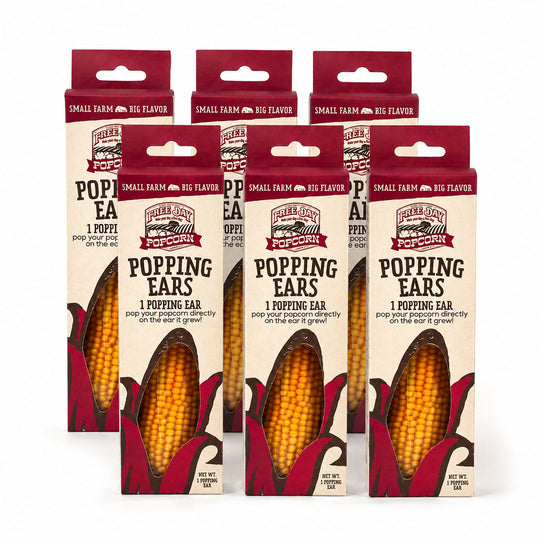 Five packages of 'Popping Ears' popcorn on a white background