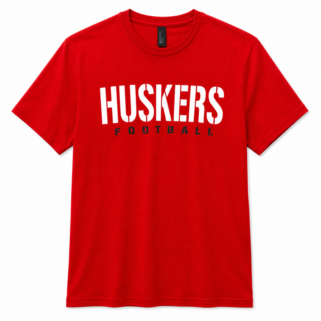 Red t-shirt with 'HUSKERS FOOTBALL' text on a white background