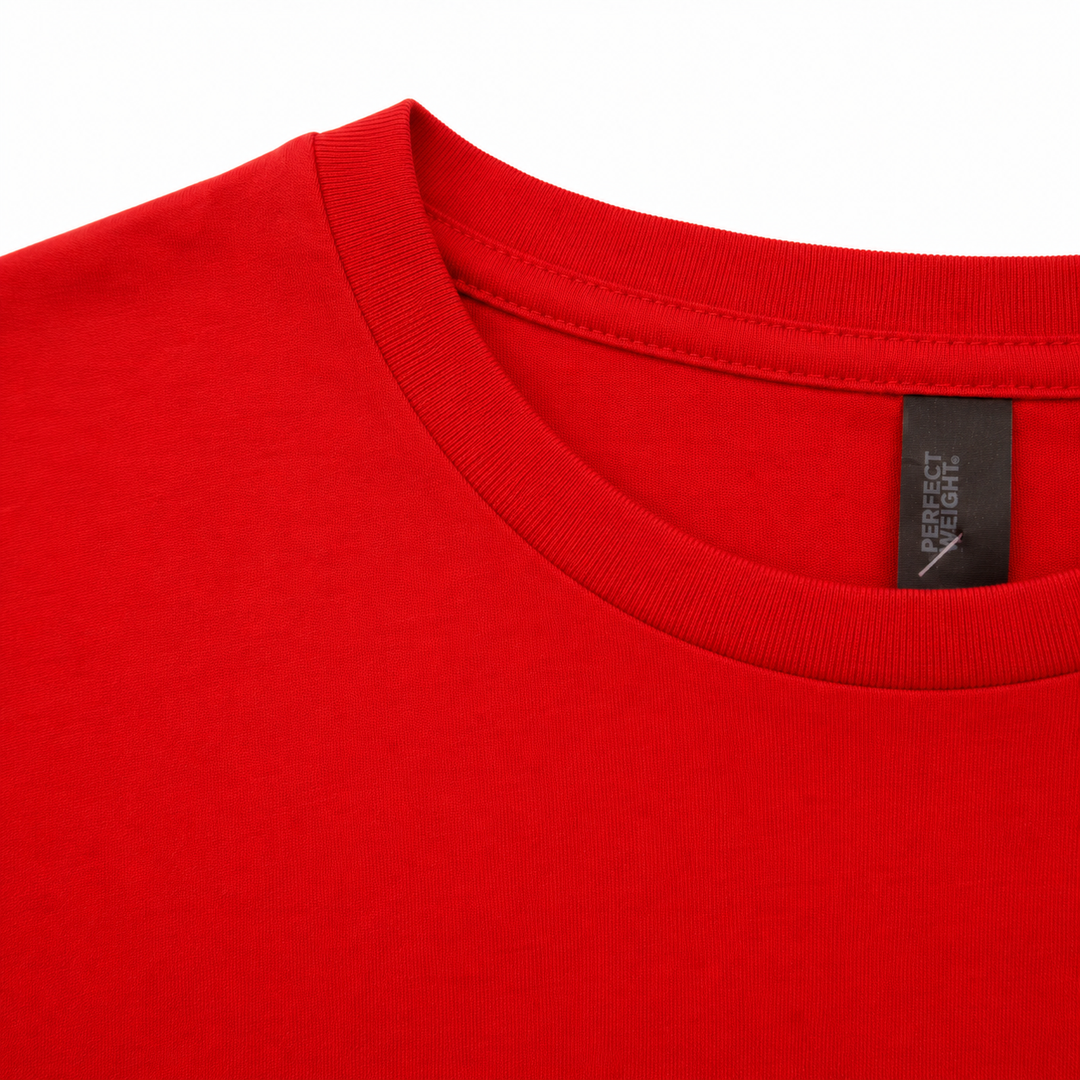 Close-up of a red t-shirt with a brand label on a white background