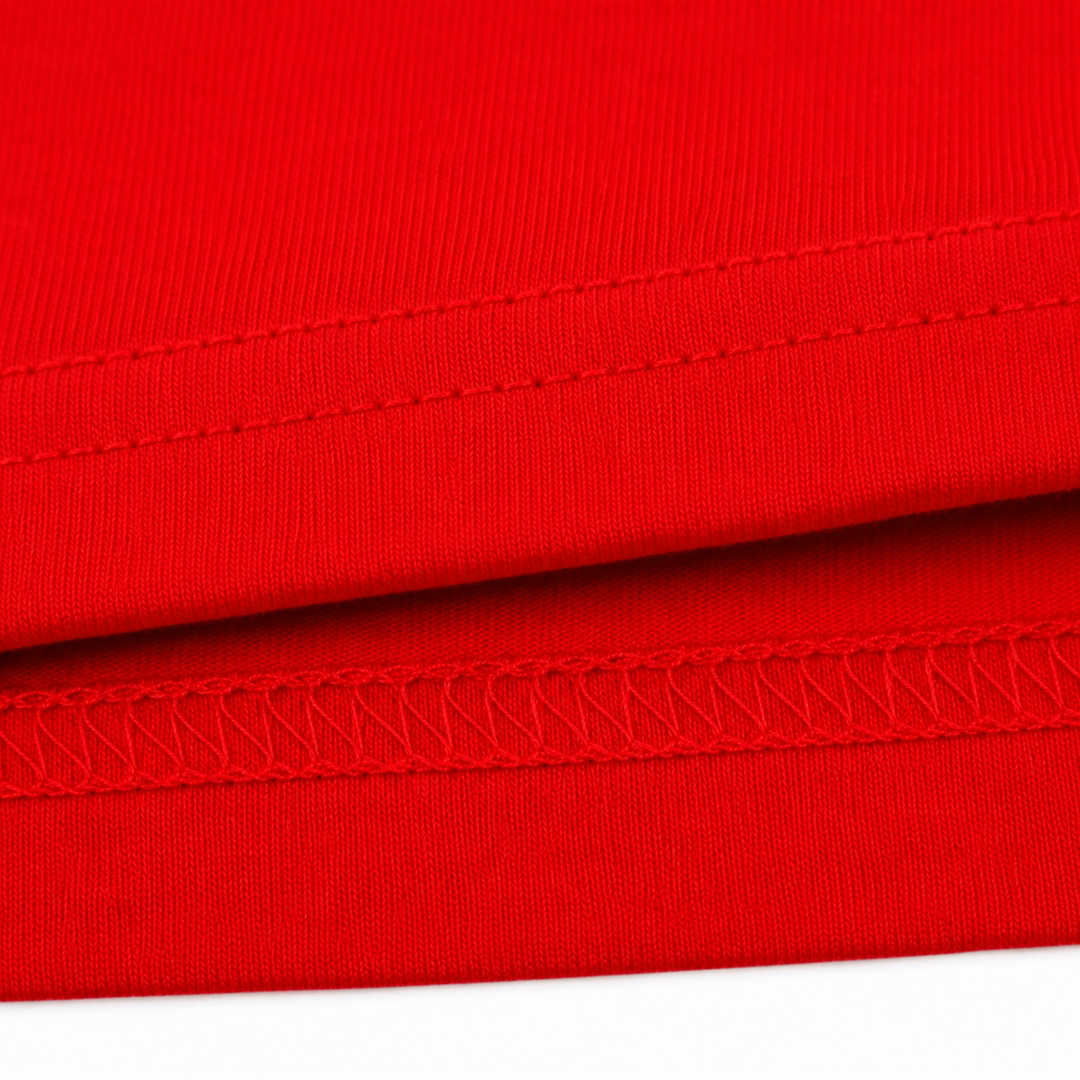 Close-up of red fabric with visible stitching on a white background