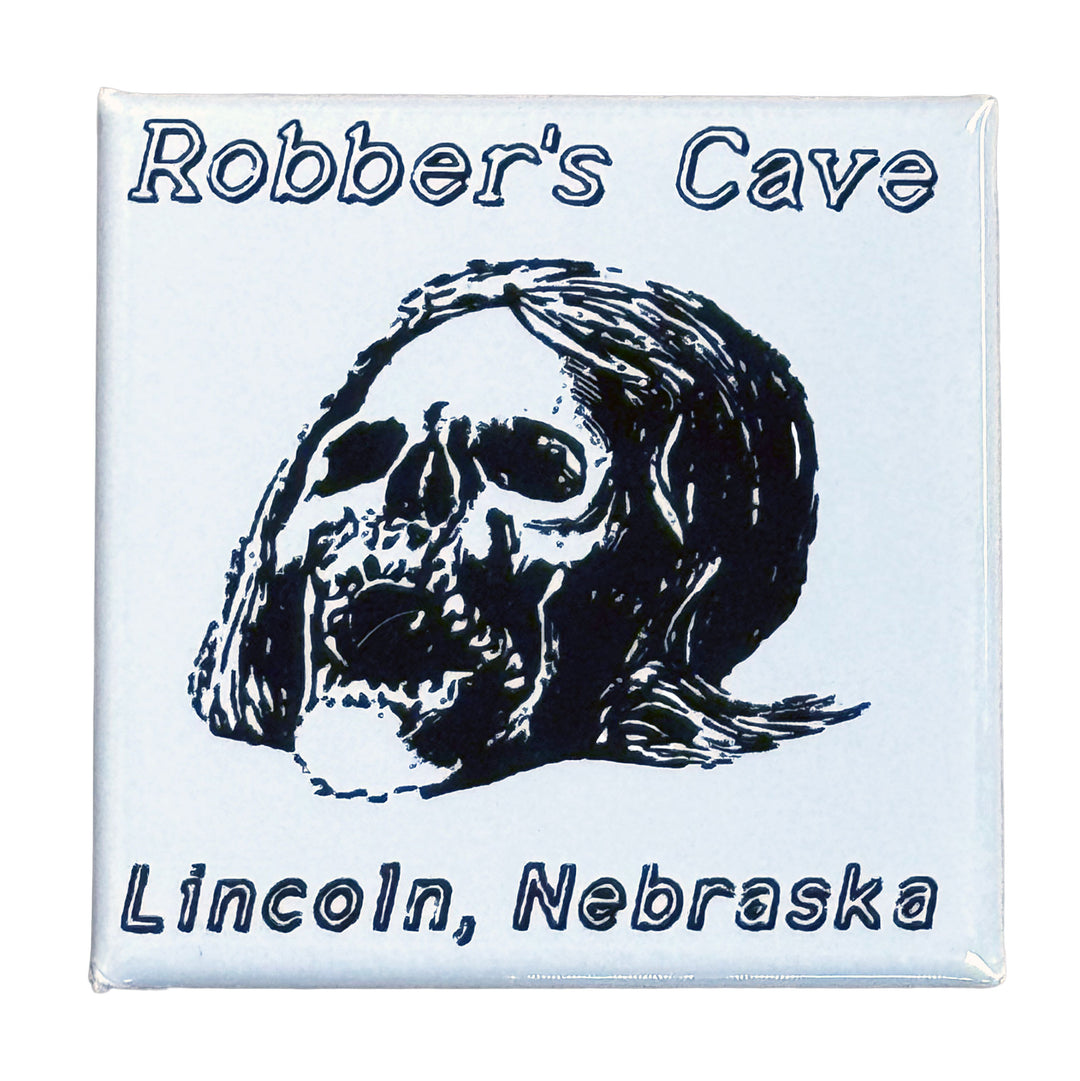 Fridge magnet with a skull design and text 'Robber's Cave Lincoln, Nebraska' on a white background