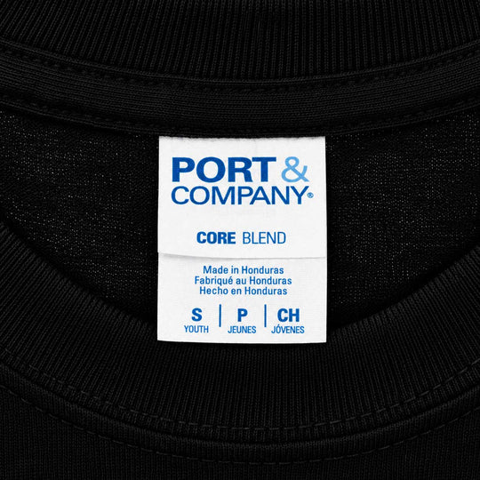 Close-up of a black ribbed garment neck label reading PORT & COMPANY CORE BLEND, with size information for Youth, Young, and Children.