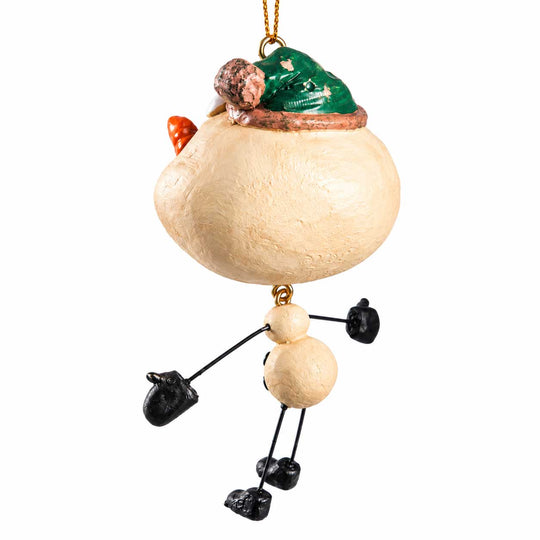A whimsical Christmas ornament shaped like a person made from natural elements. The body is a large textured beige gourd, with a smaller beige bead for the neck, black-painted stick arms and legs, black mittens, a green hat, and a small orange carrot nose.