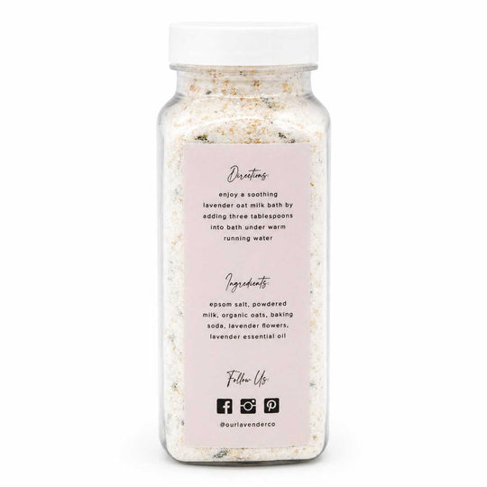 Bottle of lavender oat milk bath with a white cap on a white background