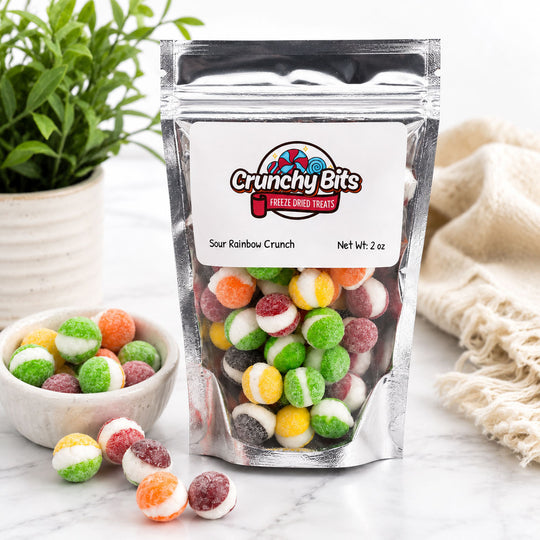 Packaged Crunchy Bits freeze-dried treats with colorful gummy candies on a white surface.
