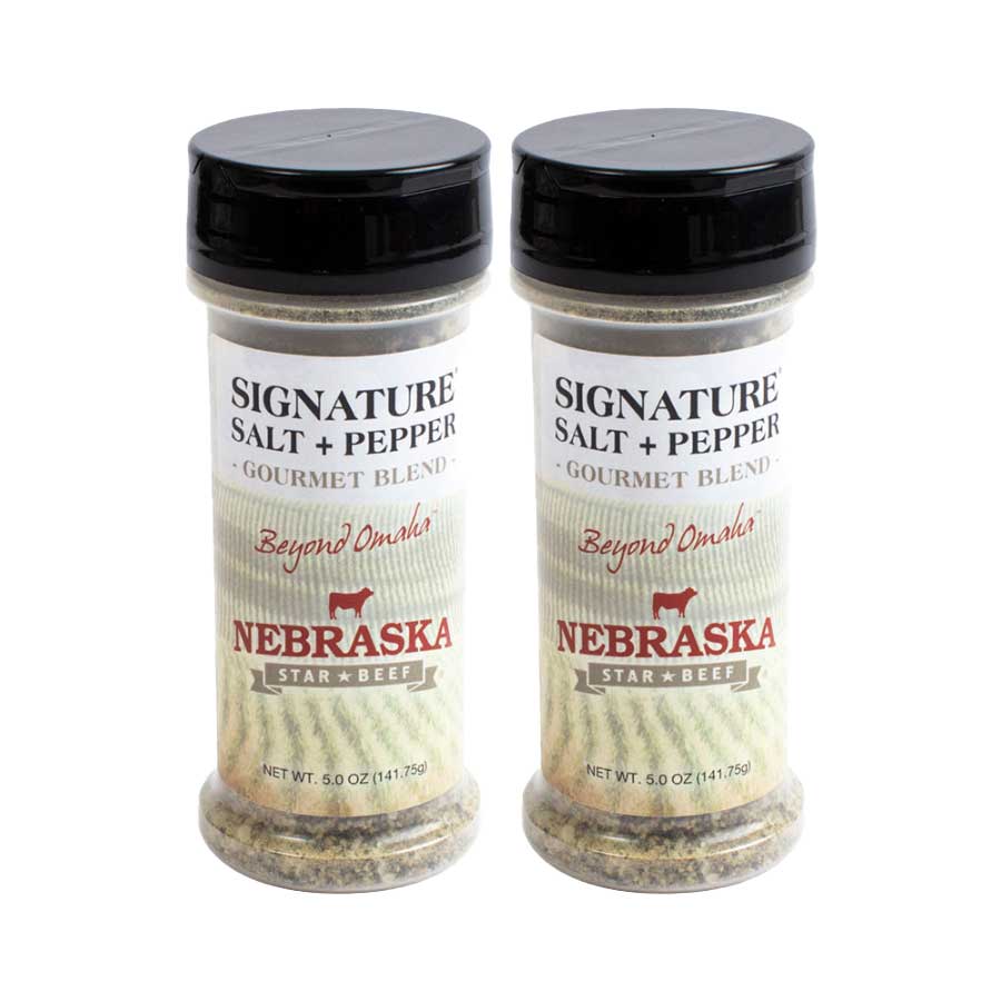 Two bottles of Nebraska Star Beef Signature Salt + Pepper on a white background