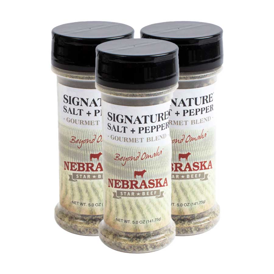 Three bottles of Nebraska Star Gourmet Blend salt and pepper on a white background