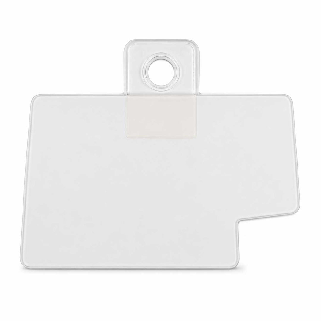 A clear plastic sticker with a rounded rectangular body, a small circular cutout at the top, and a stepped bottom-right corner, shown on a plain white background.