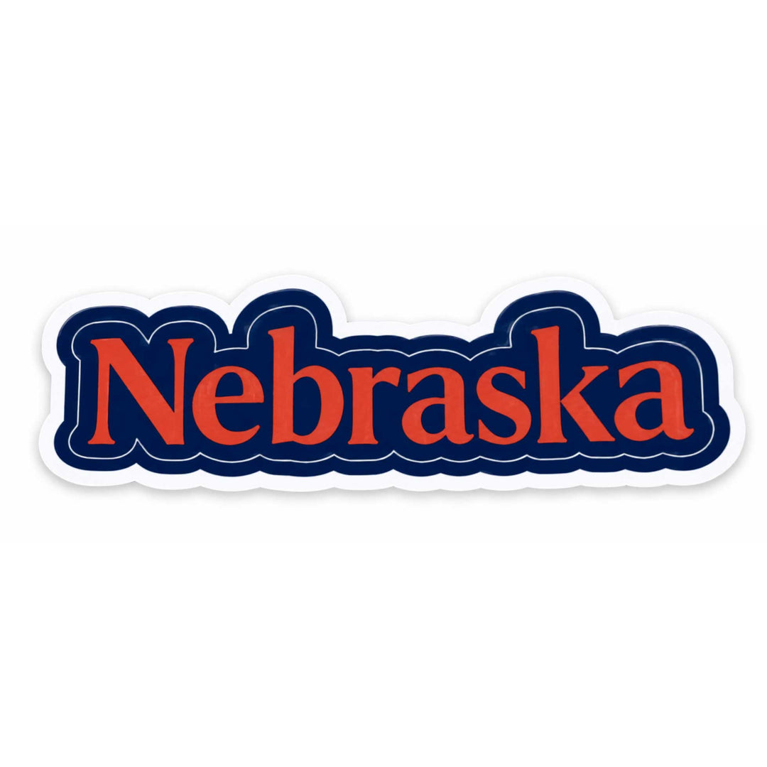 A die-cut sticker featuring the word 'Nebraska' in orange-red serif lettering with a dark navy blue outline, shown on a plain white background.