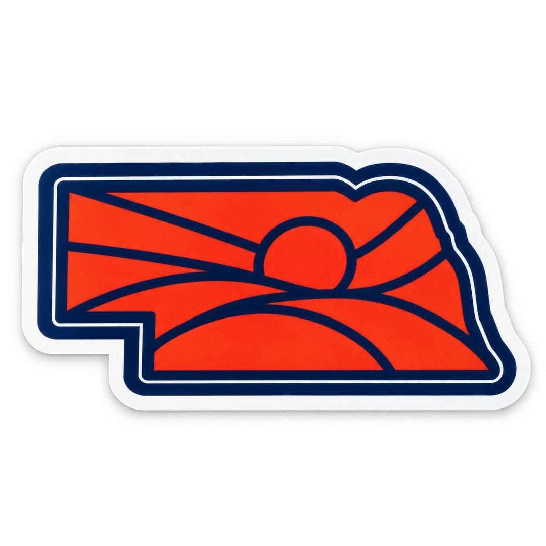 A die-cut sticker featuring the red and navy blue outline logo of the state of Nebraska, with a stylized sun and hills design, shown on a plain white background.