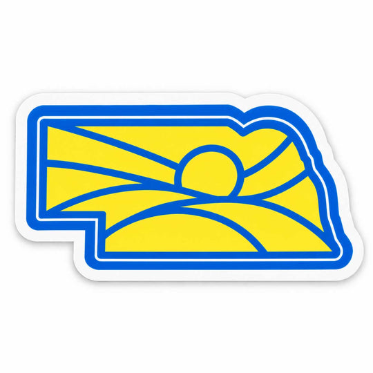 A die-cut sticker featuring the blue and yellow outline of the state of Nebraska with a stylized sun and hills design, shown on a plain white background.
