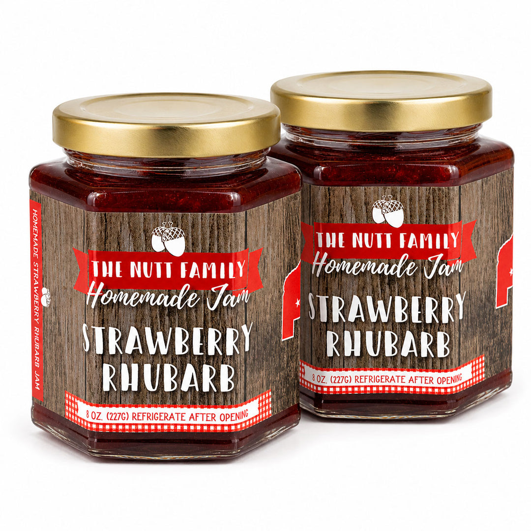 Two jars of strawberry rhubarb jam with gold lids on a white background