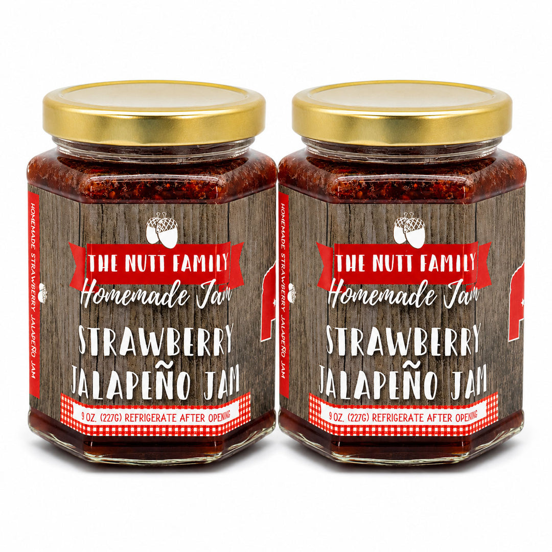 Two jars of strawberry jalapeño jam with a wooden label on a white background