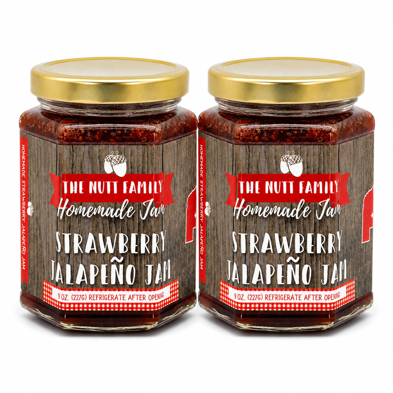 Two jars of strawberry jalapeño jam with a wooden label on a white background