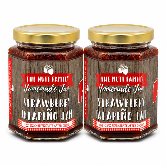 Two jars of strawberry jalapeño jam with a wooden label on a white background