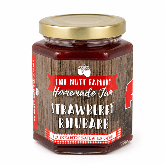 Jar of strawberry rhubarb jam with a wooden label on a white background