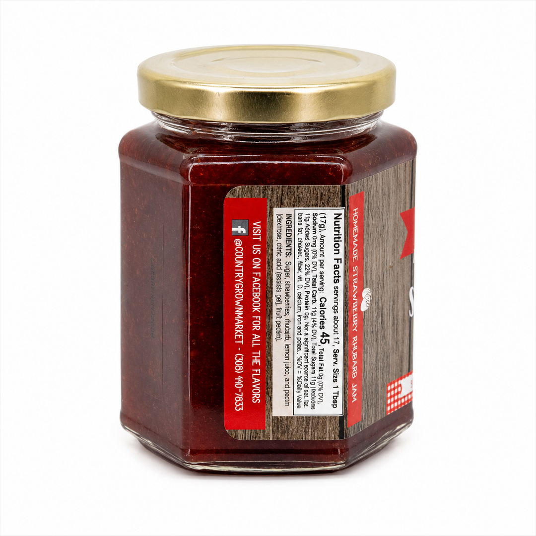 Jar of red jelly with a gold lid on a white background
