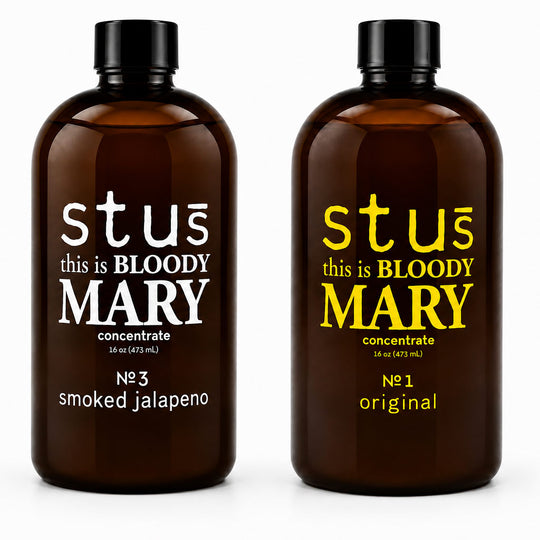 Two amber glass bottles of 'this is BLOODY MARY' spirit concentrate on a white background. The bottle on the left is labeled 'smoked jalapeno' in white text, and the bottle on the right is labeled 'original' in yellow text.