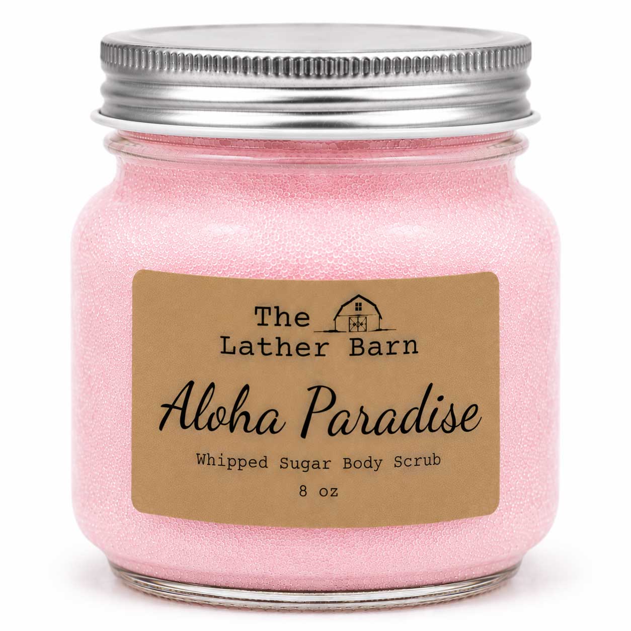 A pink whipped sugar body scrub in a clear glass jar with a silver metal lid and a brown paper label reading 'The Lather Barn Aloha Paradise Whipped Sugar Body Scrub 8 oz'.