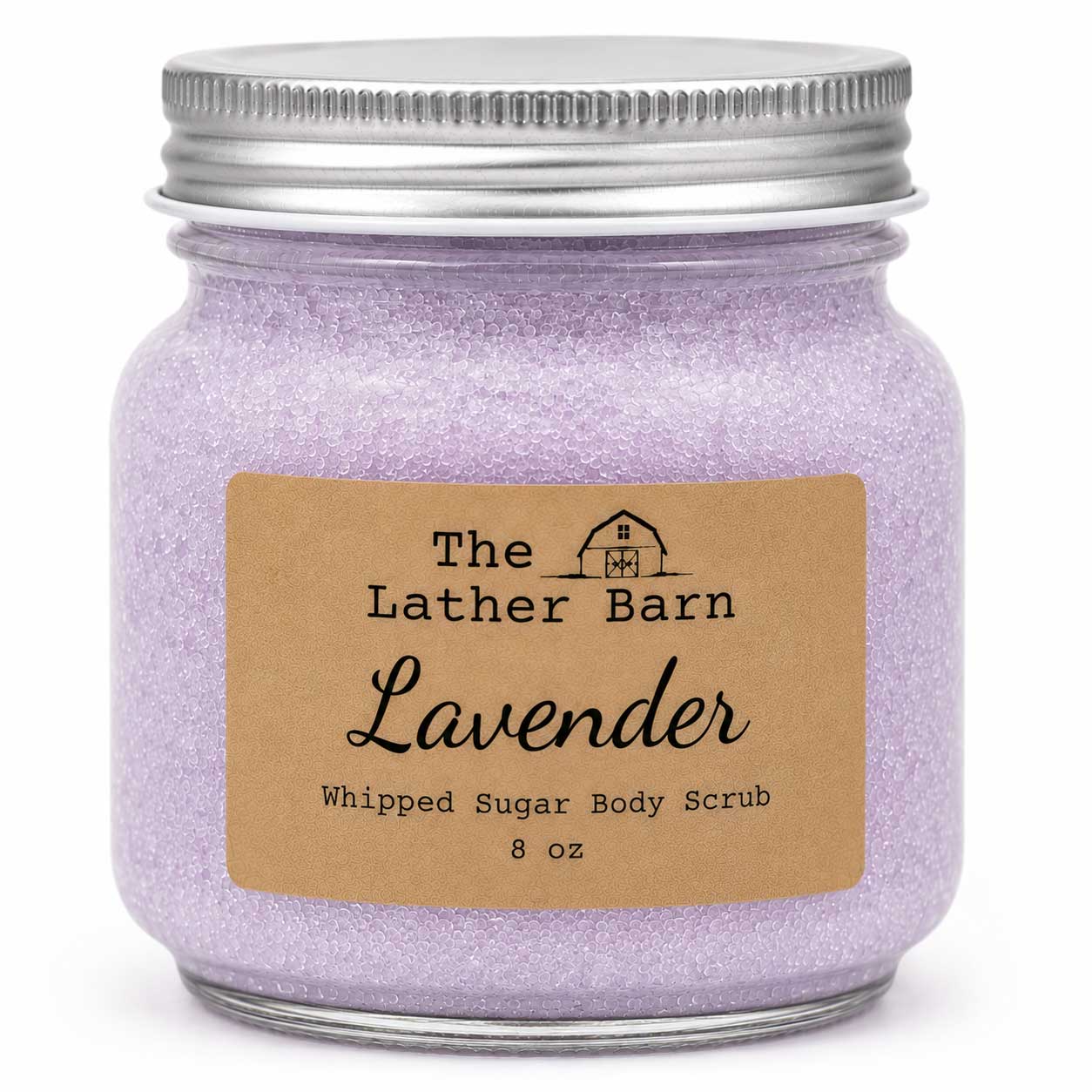 A jar of lavender whipped sugar body scrub by The Lather Barn, featuring a silver metal screw-top jar filled with light purple glittery scrub and a brown kraft paper label.