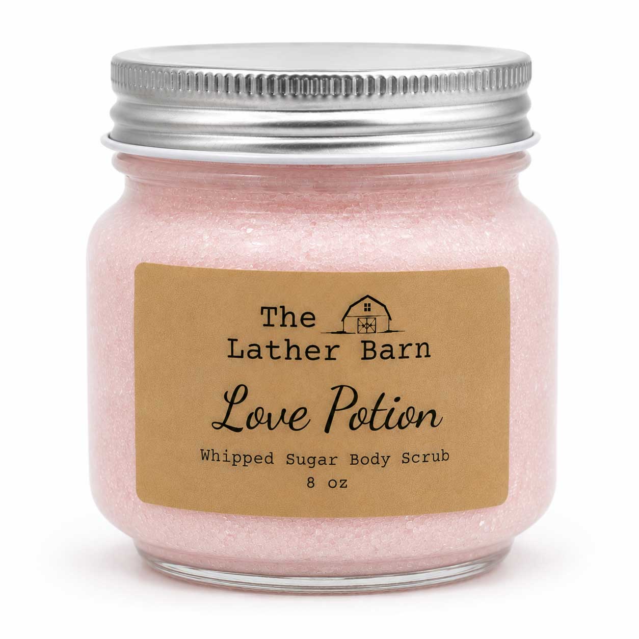 A 8 oz jar of The Lather Barn Love Potion Whipped Sugar Body Scrub, filled with light pink scrub and featuring a brown kraft paper label and a silver metal lid, set against a plain white background.