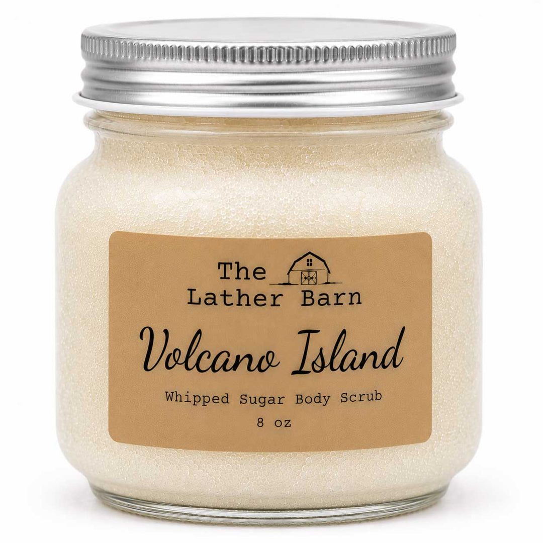 An 8 oz jar of whipped sugar body scrub by The Lather Barn, featuring a beige kraft paper label and a silver metal screw cap, shown on a white background.