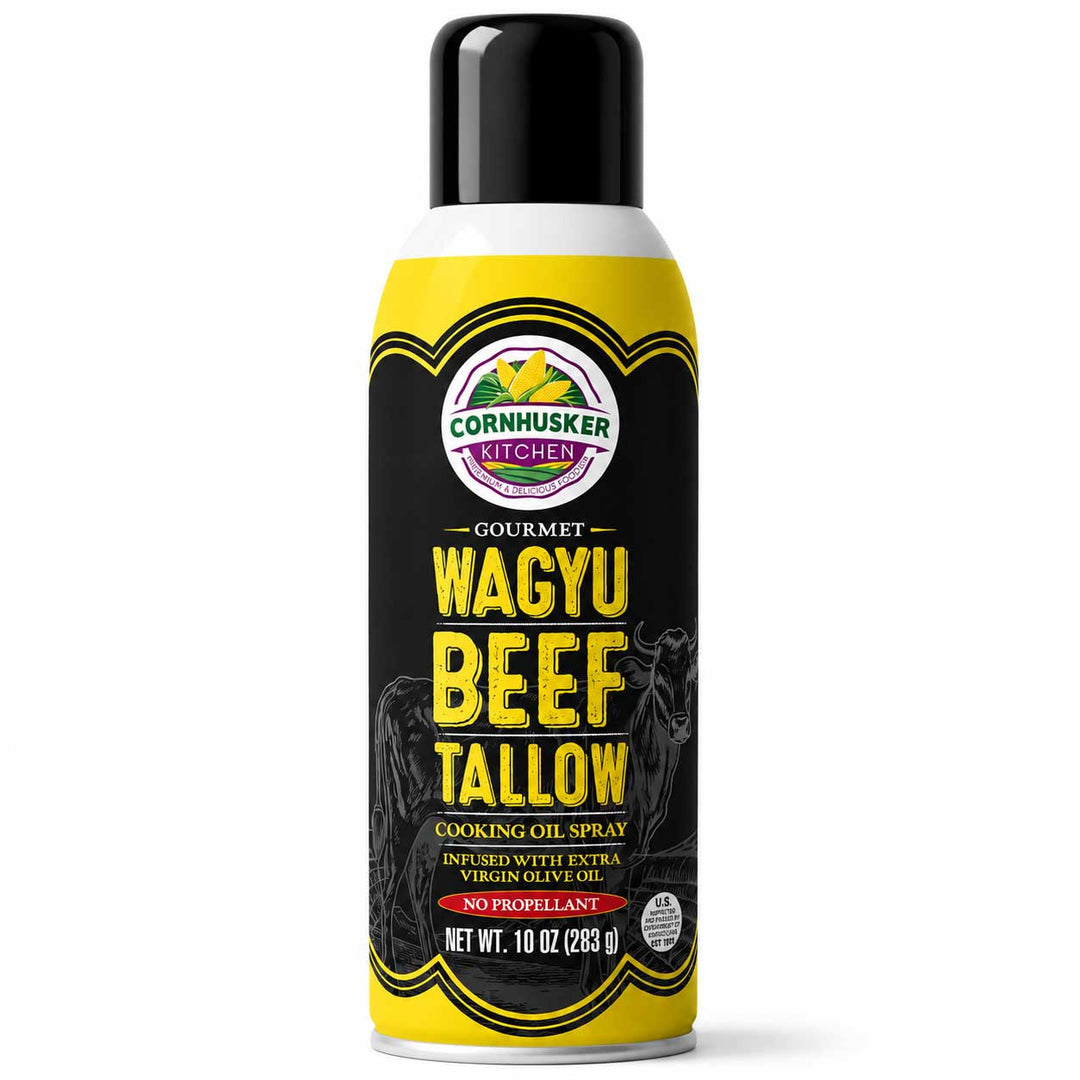 A 10 oz aerosol can of Cornhusker Kitchen Gourmet Wagyu Beef Tallow Cooking Oil Spray, featuring a black and yellow label with a black cap, set against a plain white background.