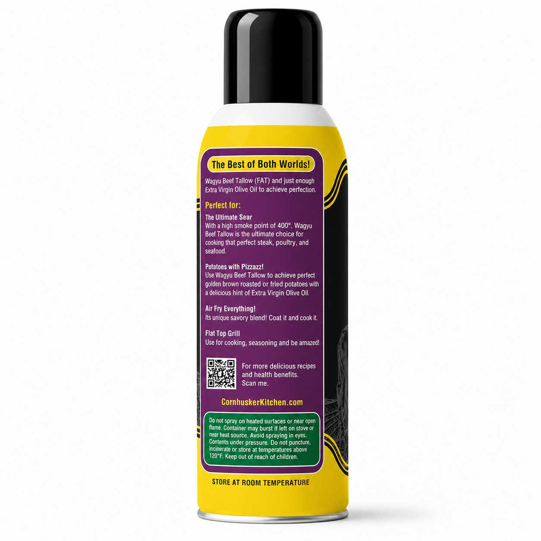 A single aerosol can of Cornhusker Kitchen Tallow cooking oil shown from the back, featuring a black cap, white top section, and a bright yellow lower section with a large purple text panel and green informational block at the bottom.