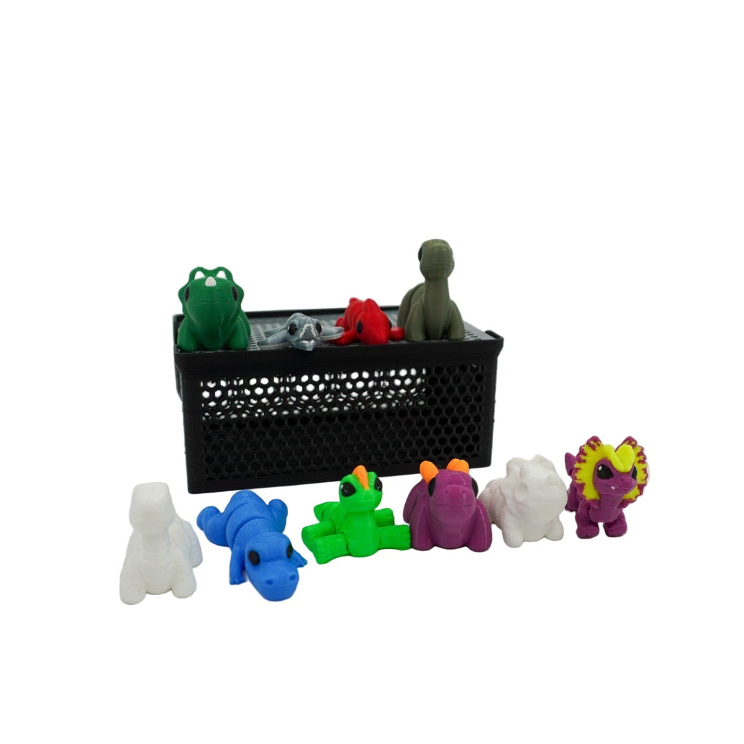 Colorful toy figures in front of a black crate on a white background