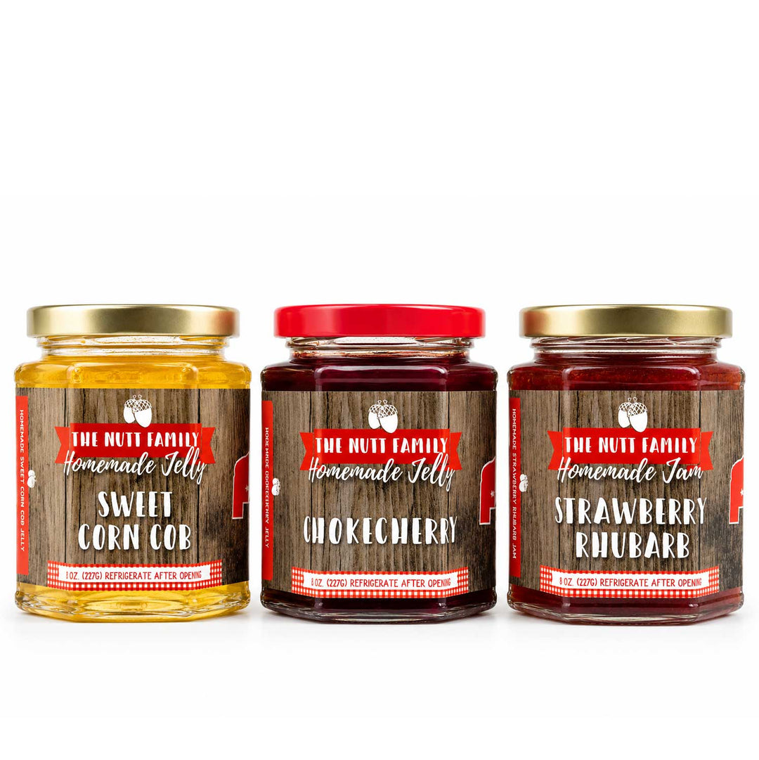 Three jars of homemade jelly with labels on a white background