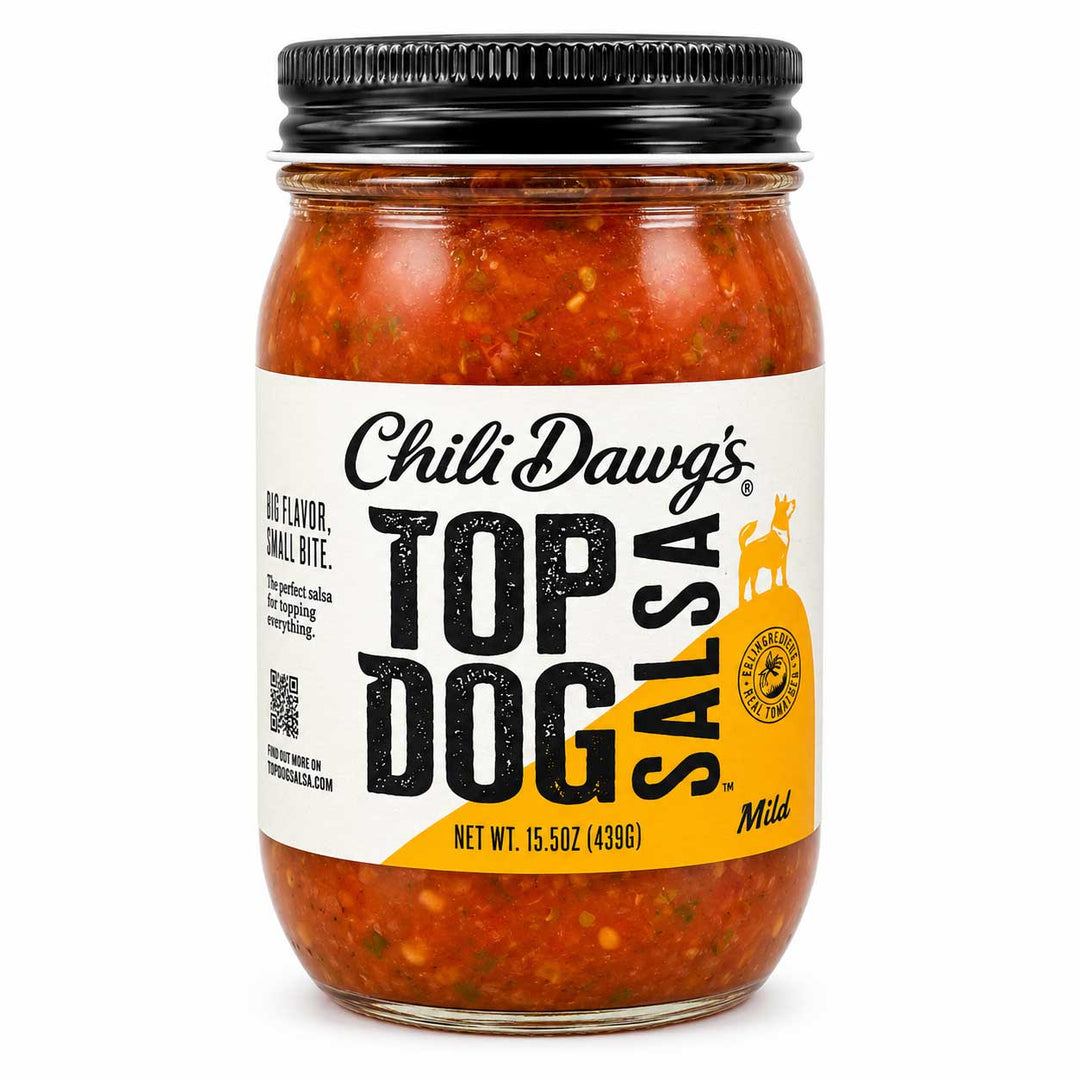A jar of Chili Dawg's Top Dog Salsa, Mild, featuring a clear glass jar filled with chunky red-orange salsa, a white and yellow label, and a black metal lid, set against a plain white background.