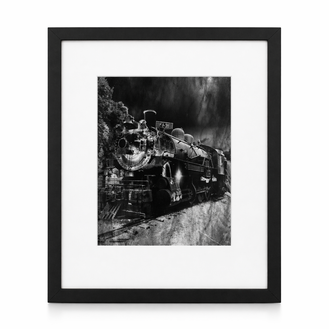 Framed black and white photograph of a vintage steam locomotive.
