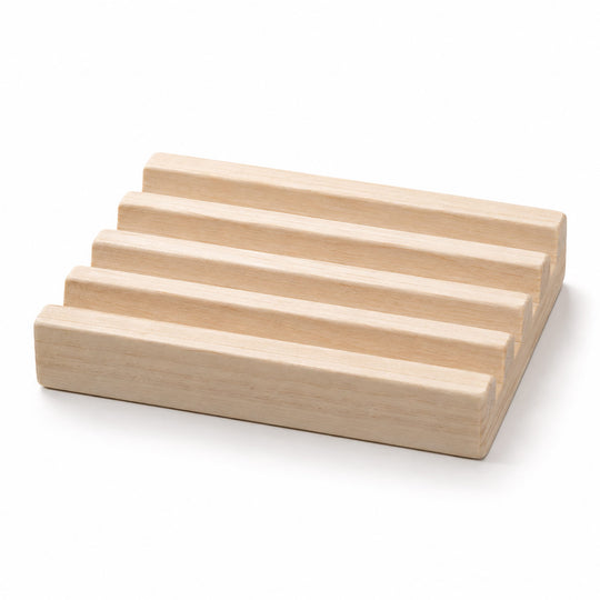A set of five light natural wood rectangular blocks arranged in a staggered, stepped stack on a clean white background.