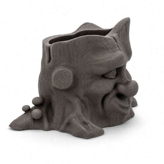 Ceramic face-shaped planter on a white background