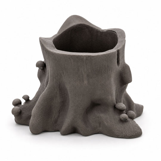 Ceramic planter shaped like a tree stump with bulbous ends on a white background