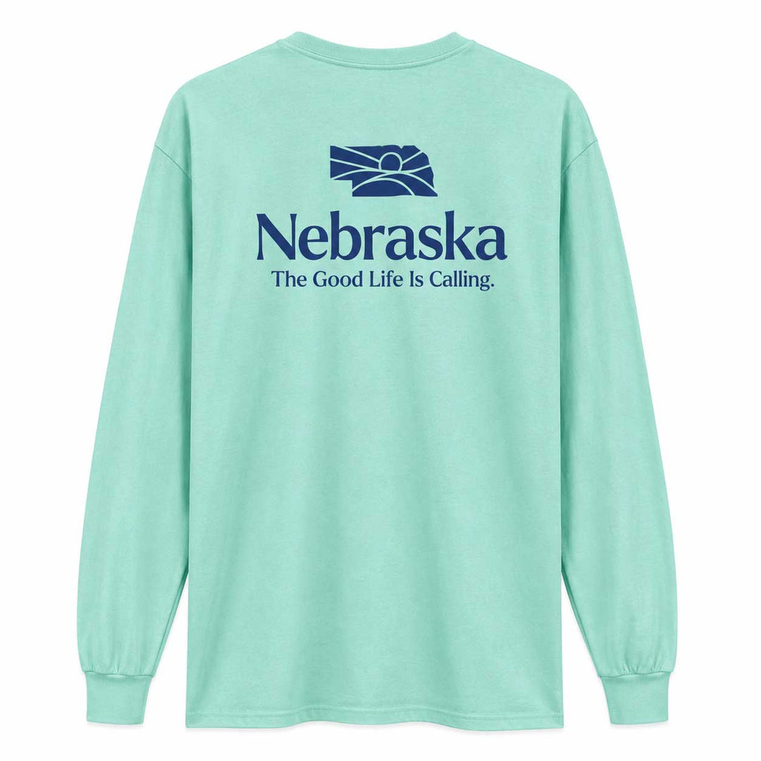 A mint green long-sleeve t-shirt shown from the back, featuring a dark blue graphic of the Nebraska state silhouette with a rising sun and the text 'Nebraska The Good Life Is Calling.' printed on the back.