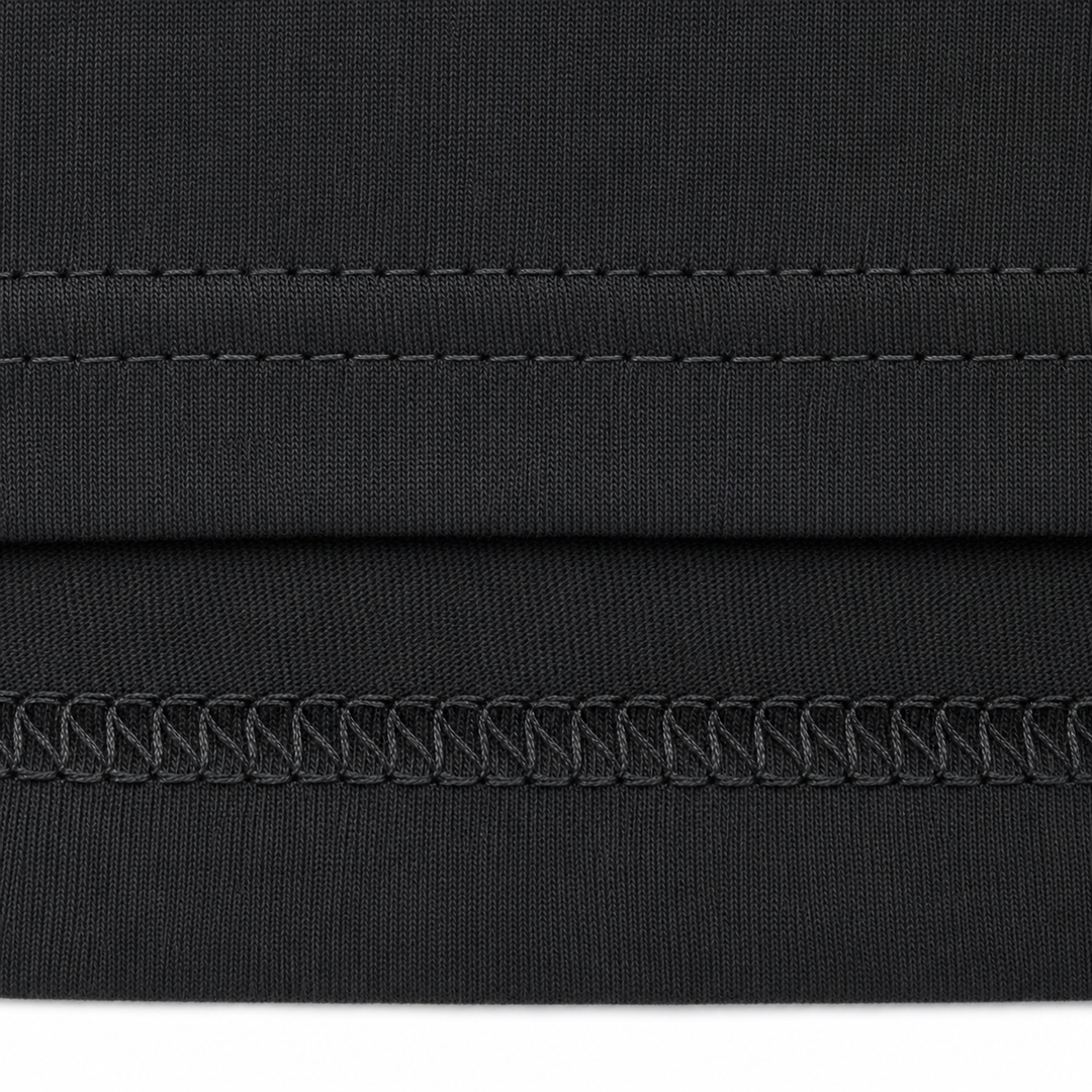 Close-up of black fabric with stitching detail on a white background