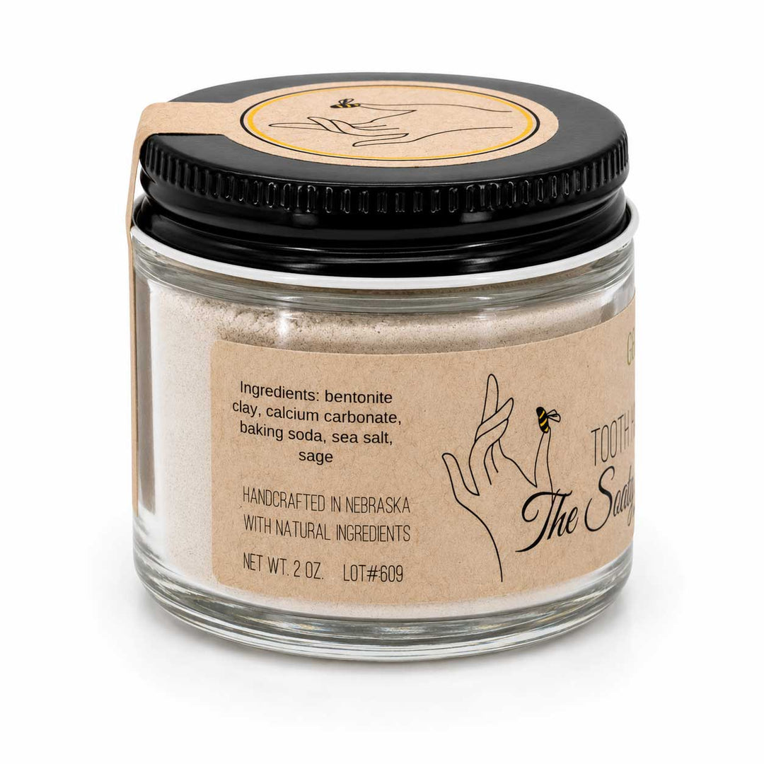 Glass jar with black lid and brown label on a white background