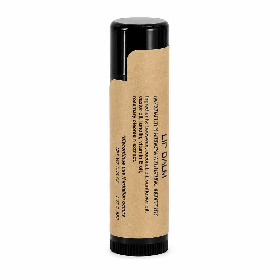 Lip balm with a black cap and brown body on a white background