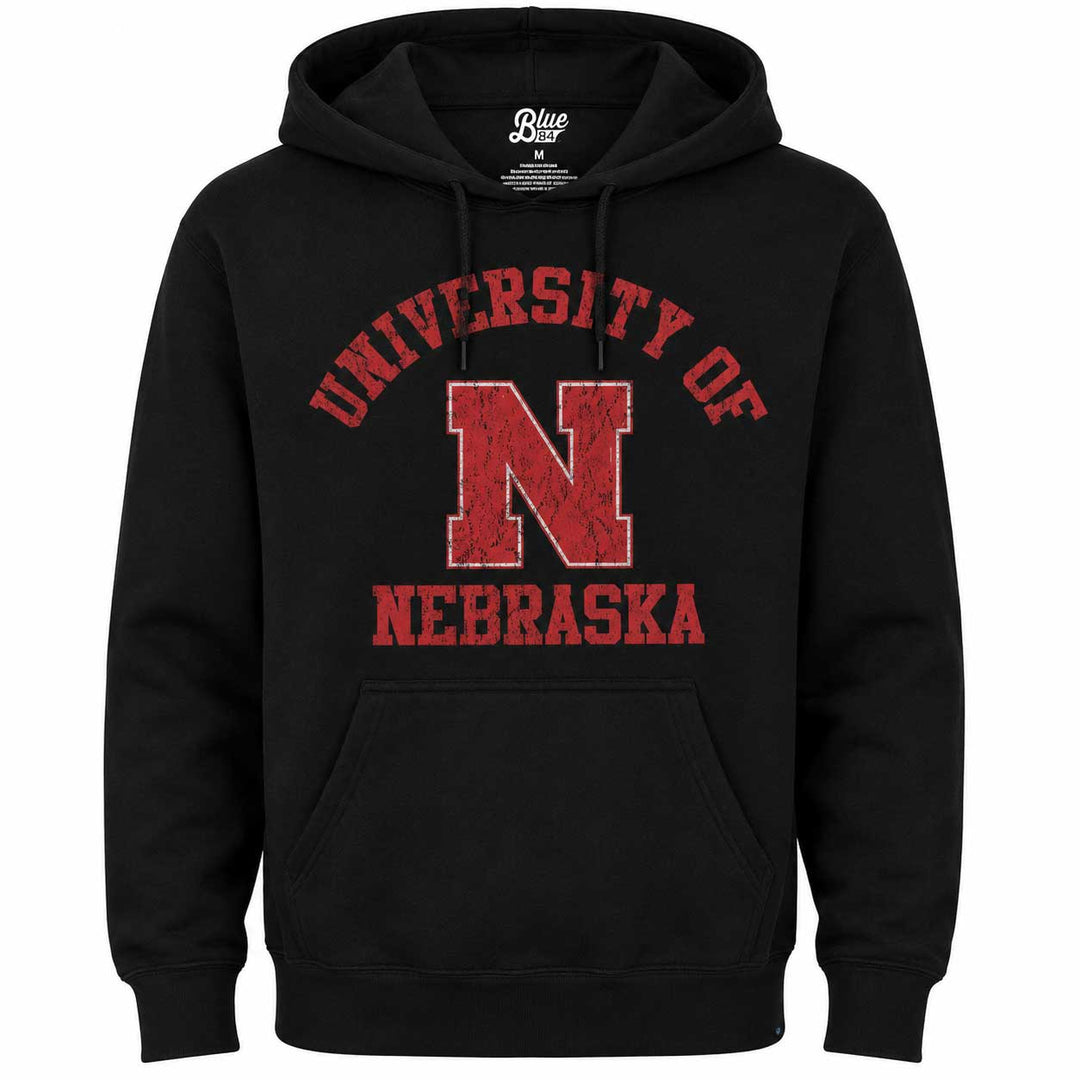 A black pullover hoodie with a distressed red graphic on the chest reading 'UNIVERSITY OF NEBRASKA' around a large block 'N'. The hoodie has drawstrings, a front kangaroo pocket, and a visible 'Blue Door' neck label.