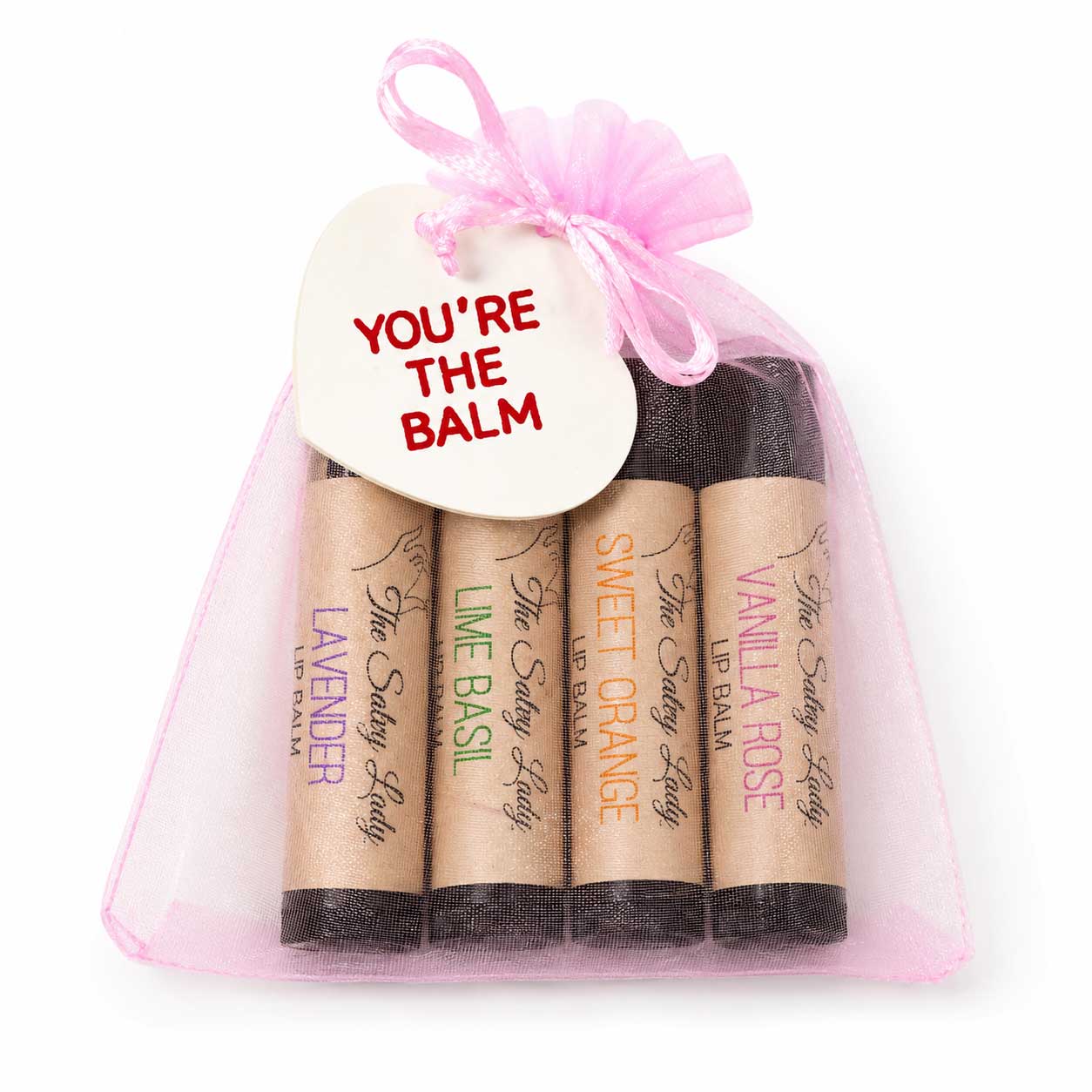 Set of lip balms in kraft paper packaging with a pink sheer bag and 'You're the Balm' tag.