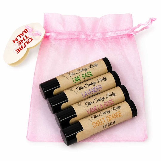Set of lip balms with visible brand names on a pink drawstring bag.