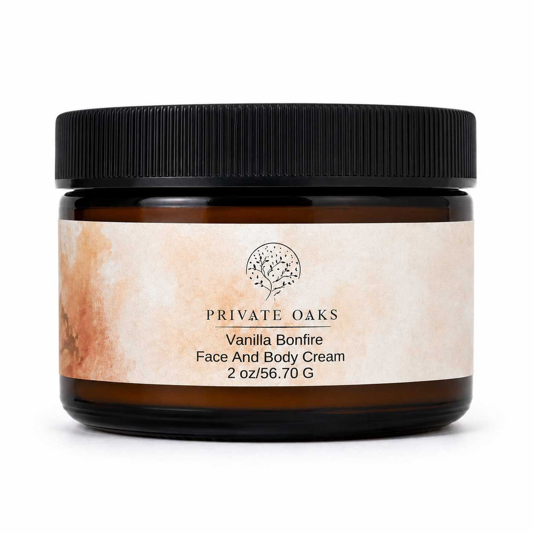 A jar of Private Oaks Vanilla Bonfire Face And Body Cream, featuring a black ribbed screw cap and a textured beige label with a tree logo, set against a plain white background.