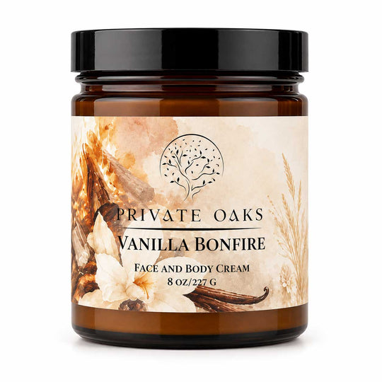 A jar of Private Oaks Vanilla Bonfire Face and Body Cream, featuring a black lid and a warm-toned label with vanilla bean illustrations, set against a plain white background.