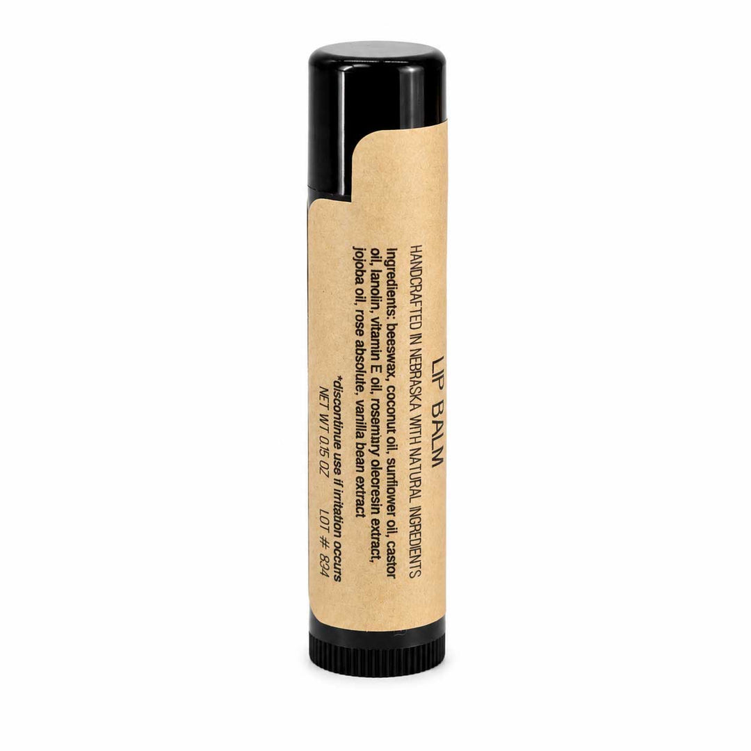 Lip balm with a black cap and kraft paper packaging on a white background