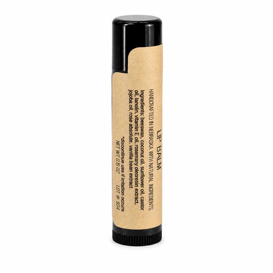 Lip balm with a black cap and kraft paper packaging on a white background