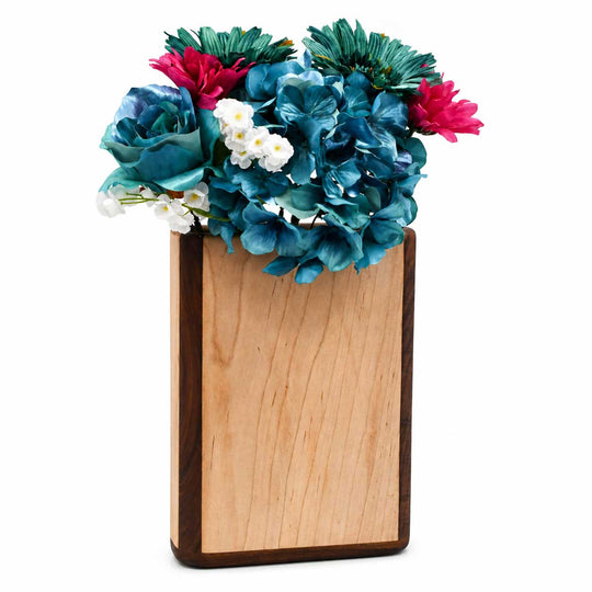 Wooden vase with colorful flowers on a white background