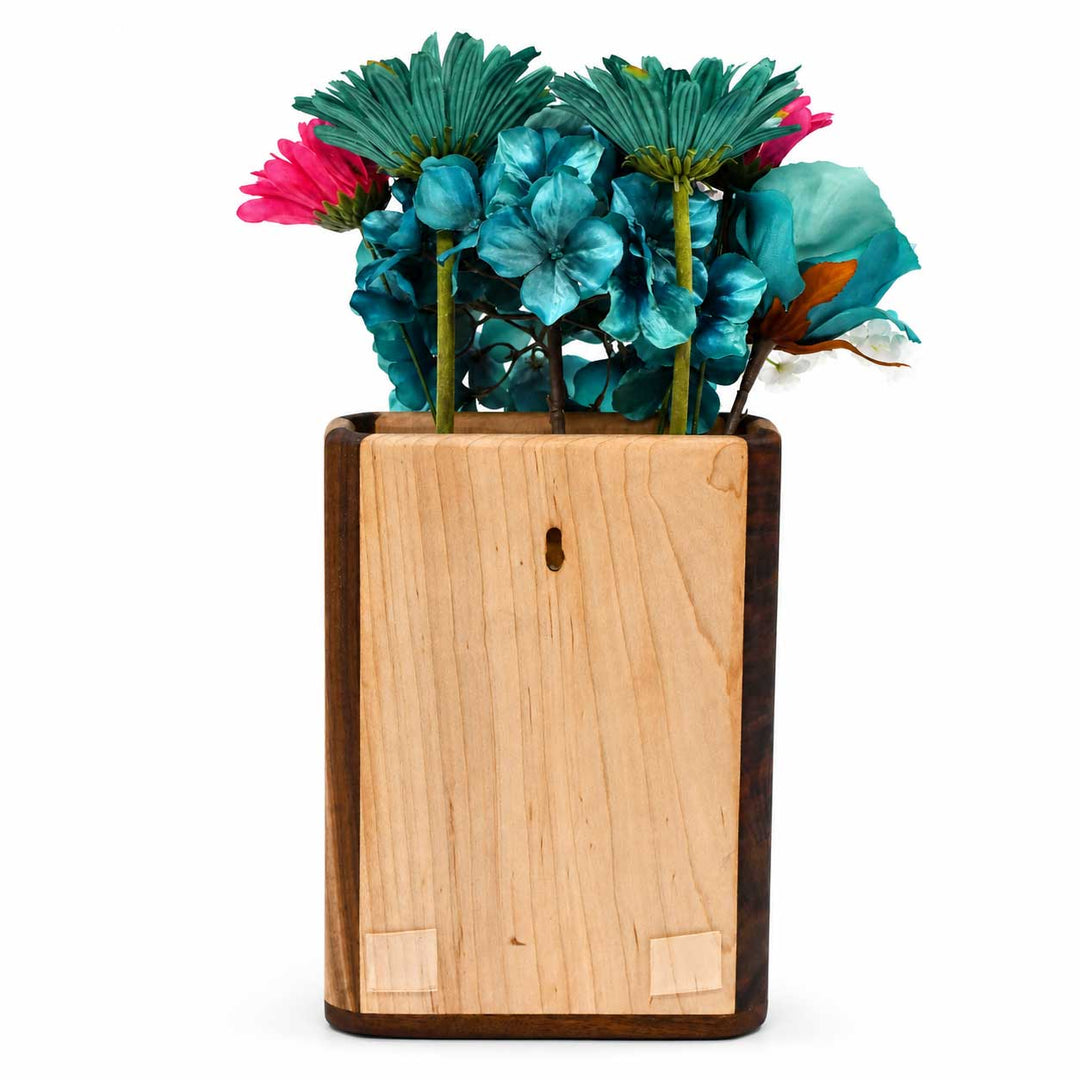 Wooden vase with colorful flowers on a white background