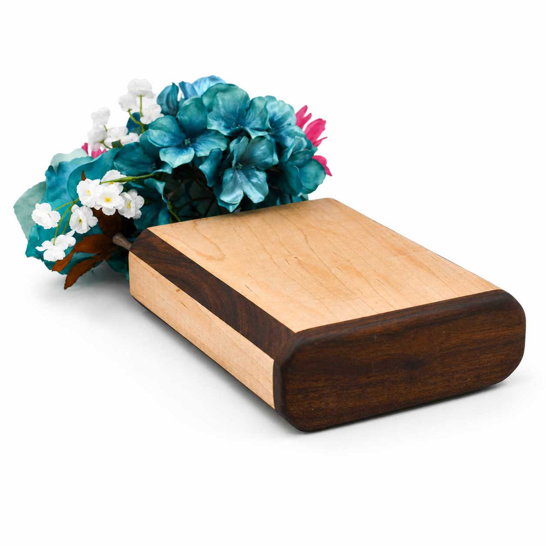 Wooden vase with floral arrangement on a white background